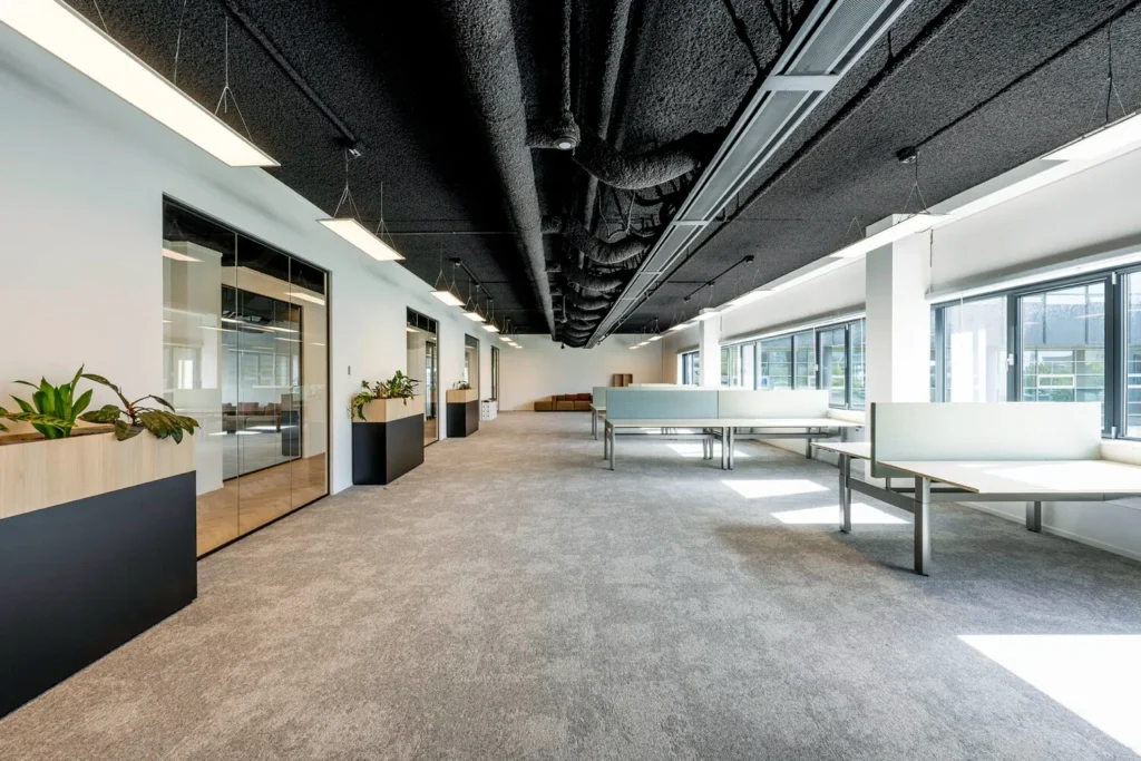 Moderne open kantoorruimte met grote ramen en strakke inrichting op Transformatorweg 76.